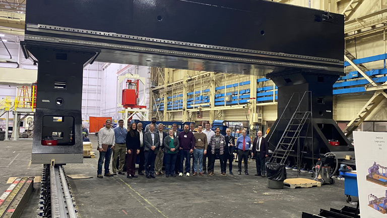 Jointless Hull project team standing under the the full-scale tool being manufactured.